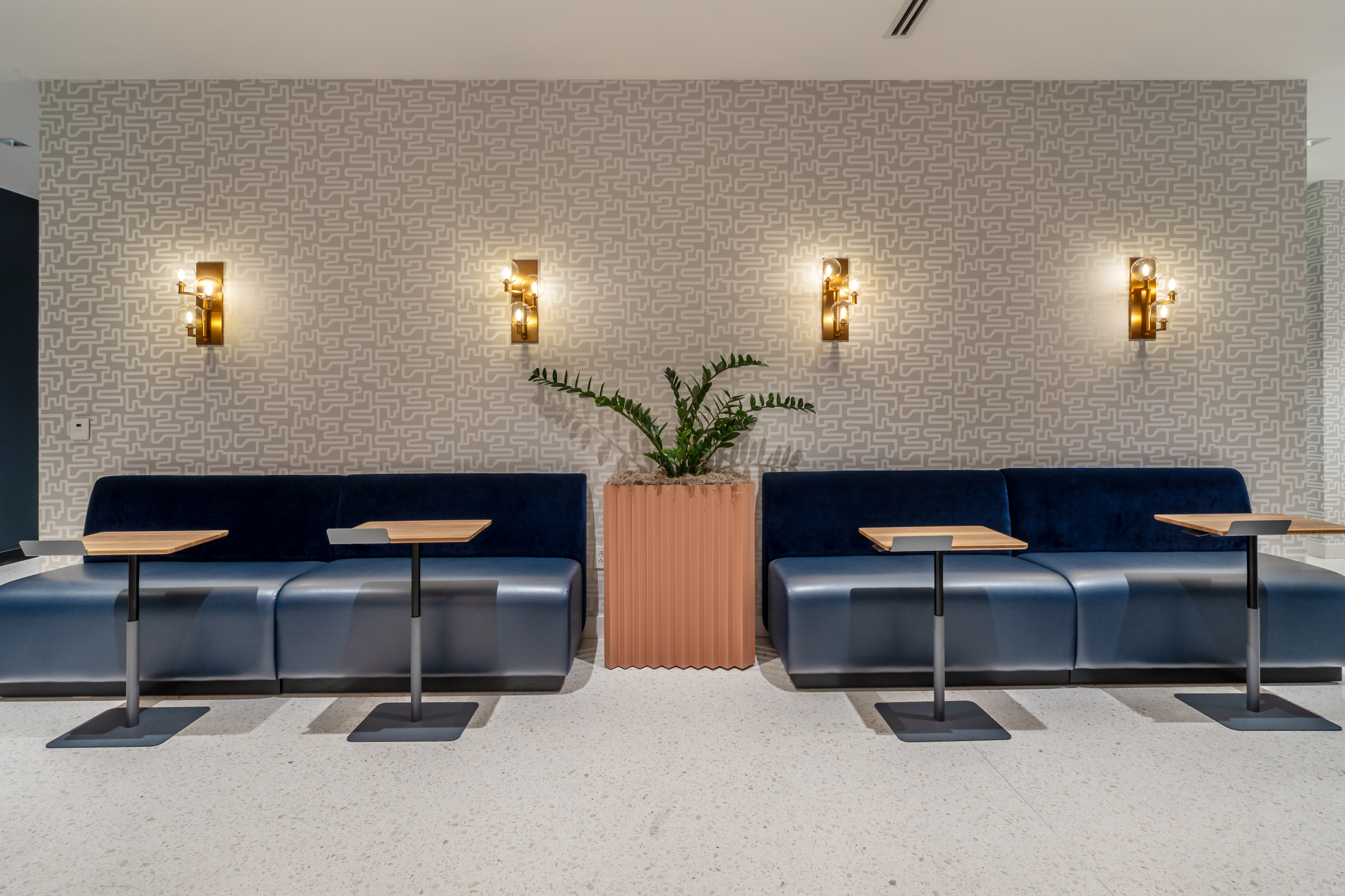 a blue couches and tables in a room