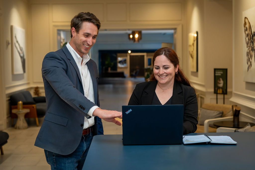 man and woman reviewing a computer screen